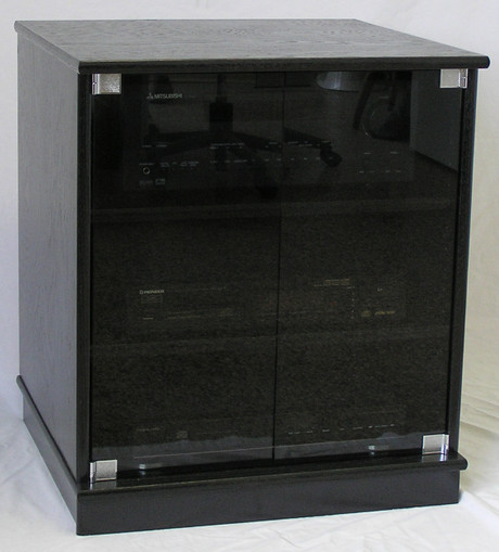 of small black oak TV stand with gray tint glass doors 