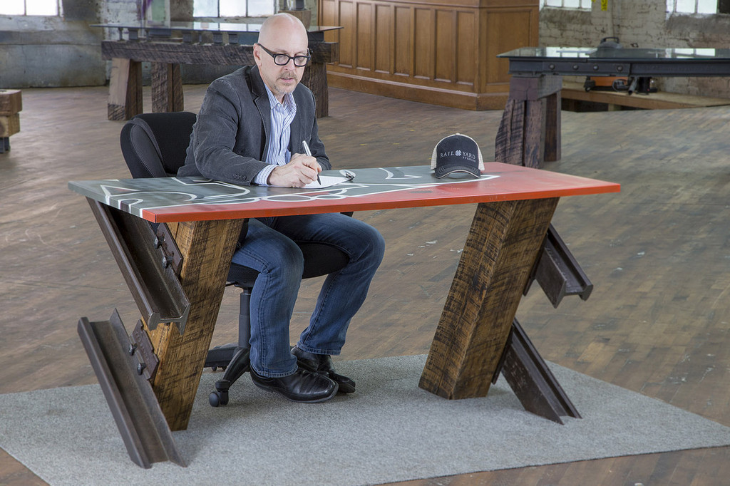 urban loft graffiti art style desk with reclaimed wood and steel legs in renovated warehouse