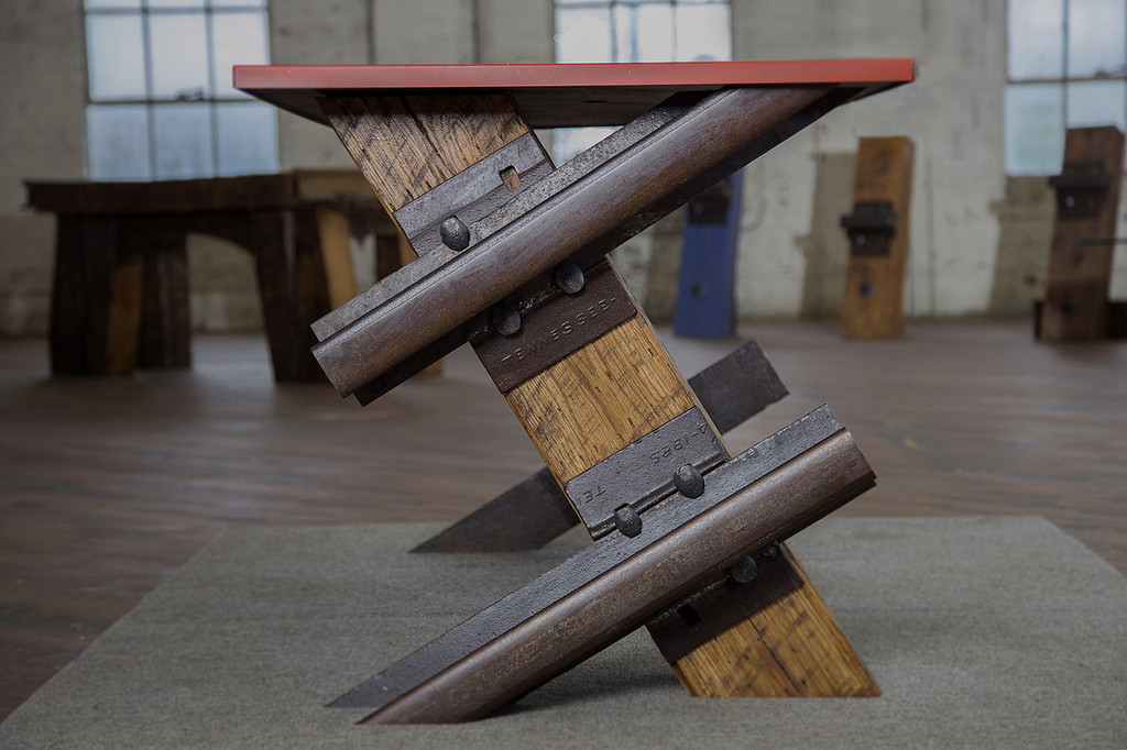 cantilevered steel and wood table desk with red desktop