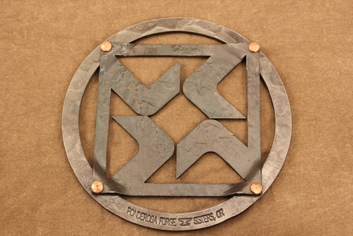 iron trivet with black butte ranch logo
