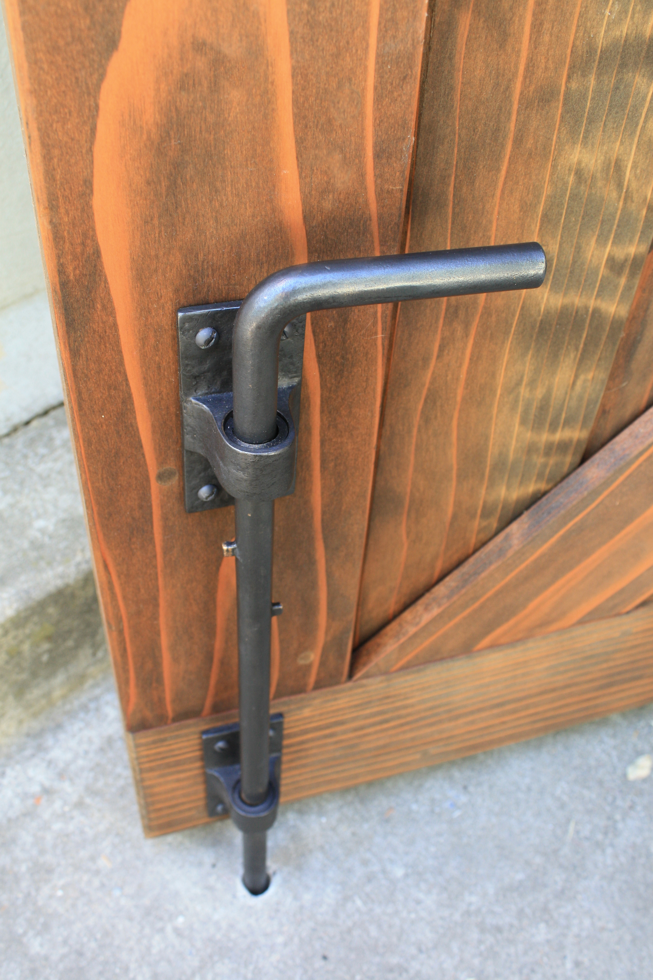 coastal-bronze-80-100-cane-bolt-holding-open-a-double-gate.jpg