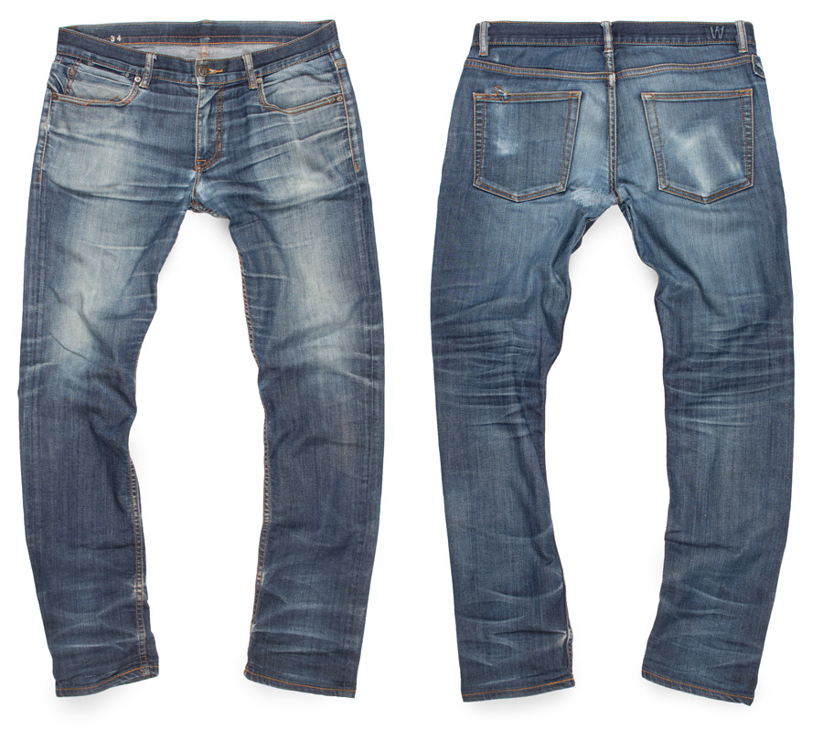 raw denim jeans aged and faded to light blue distressed color