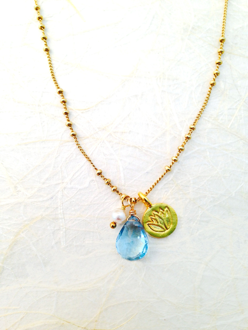 Blue Topaz Gold Lotus Charm Necklace