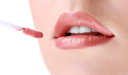 woman-applying-natural-lip-gloss-to-mouth-closeup.jpg