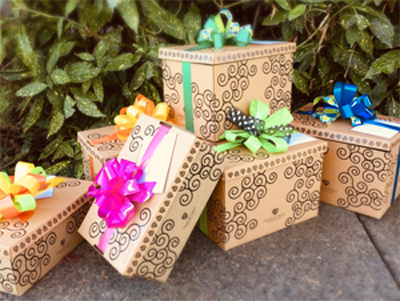 Several signature Green & Green gift boxes with colourful bows.