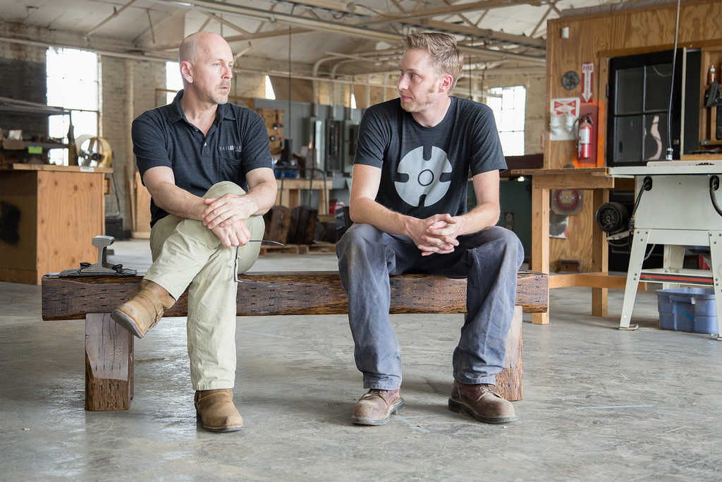 two-person modern rustic timber and steel bench in industrial setting