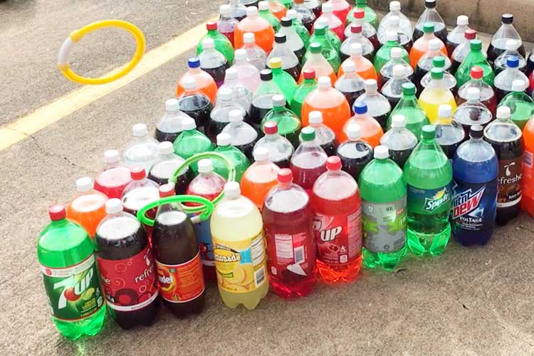 2 Liter Ring Toss Game - image of a flying tossing ring with a lot of soda bottles