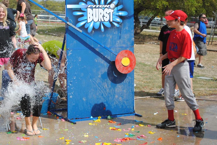 Young baseball player volunteering at a carnival booth!