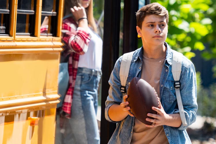 High school football player with ball - carnival volunteer