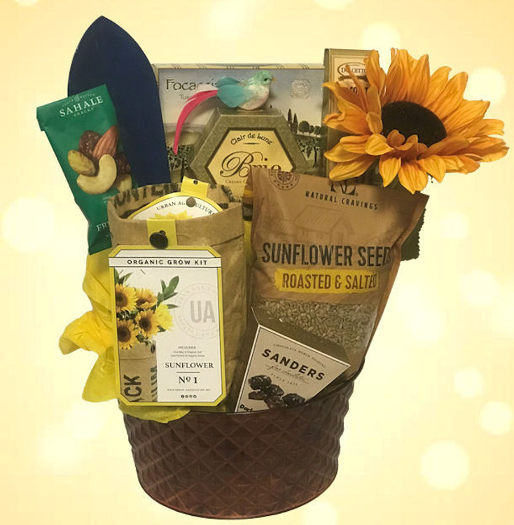 This gift will brighten their day! Includes a Sunflower growing kit, sunflower seeds, a gardening tool, chocolates, cheese, crackers, nuts, cookies, and a sun flower enhancement presented in a hammered copper metal container.